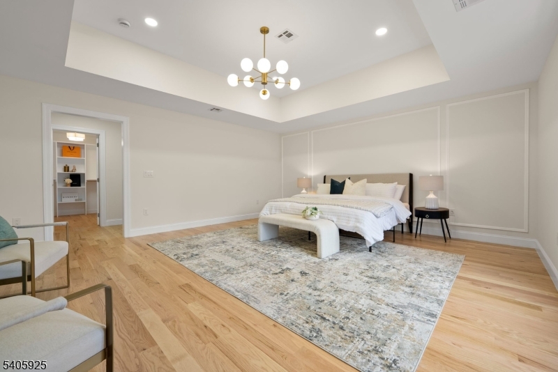 100 Louis Street Whippany, NJ 07981 - Photo 27 of 47 a bedroom with a bed and a chandelier