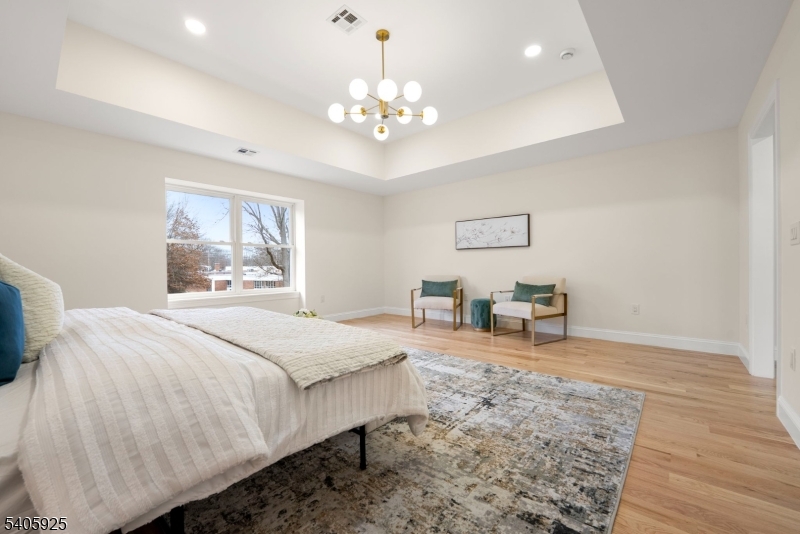 100 Louis Street Whippany, NJ 07981 - Photo 28 of 47 a bedroom with a bed chandelier and a window