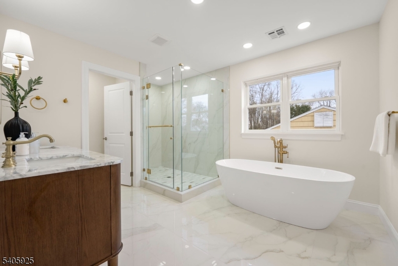 100 Louis Street Whippany, NJ 07981 - Photo 31 of 47 a spacious bathroom with a double vanity sink mirror and bathtub
