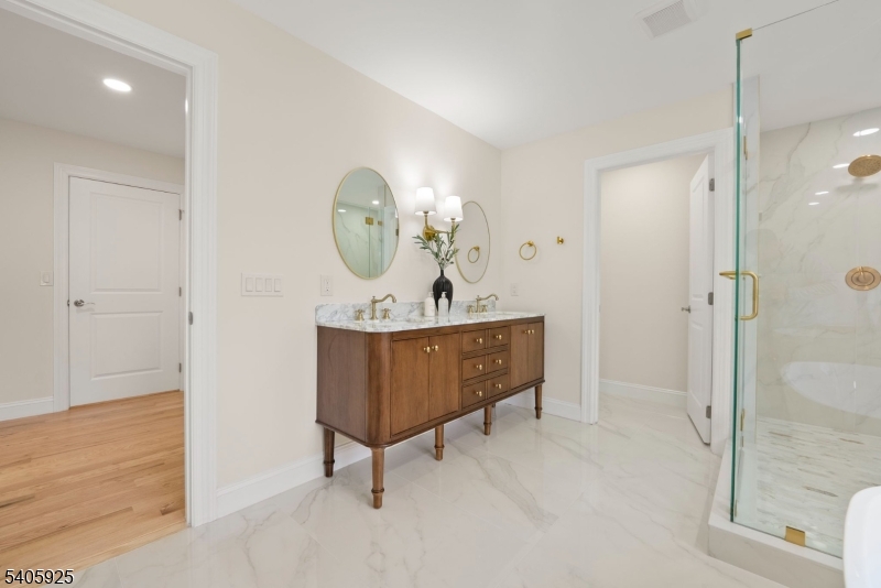 100 Louis Street Whippany, NJ 07981 - Photo 32 of 47 a room with a sink a mirror and a glass door shower