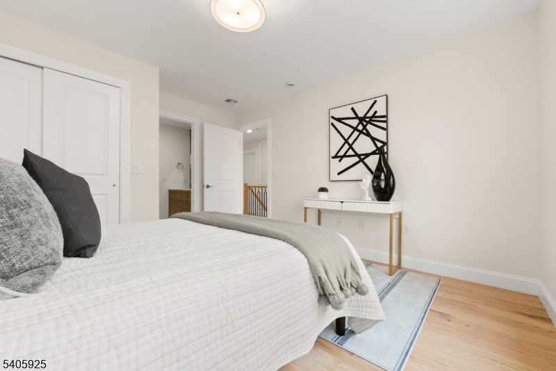 100 Louis Street Whippany, NJ 07981 - Photo 35 of 47 a bedroom with a bed and a chandelier