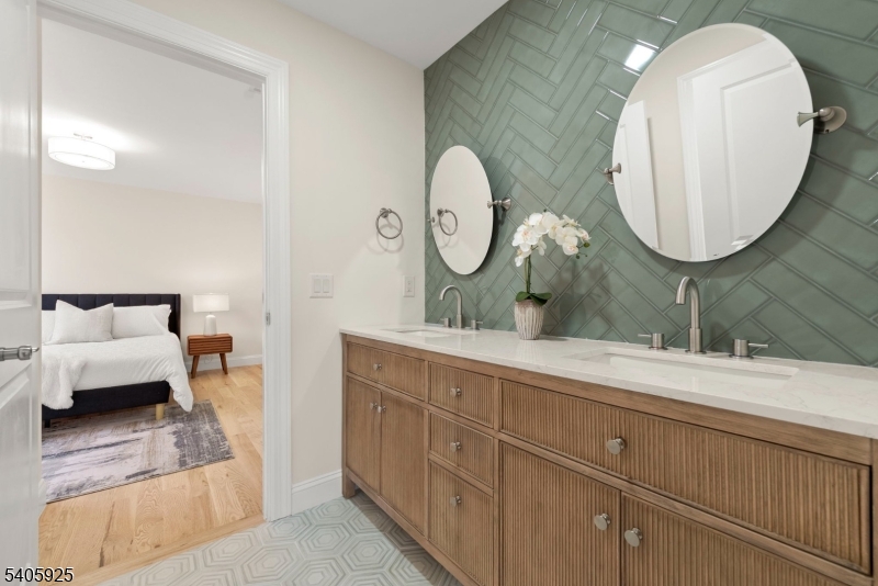 100 Louis Street Whippany, NJ 07981 - Photo 36 of 47 a spacious bathroom with a double vanity sink and a mirror