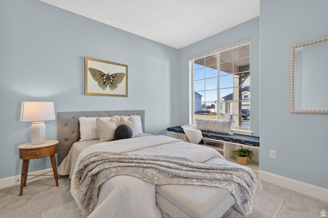 1222 West 190th Street North Mapleton, UT 84664 - Photo 31 of 46 Bright room featuring a large window with white grid panes, a built-in window seat with integrated shelving, and light blue wall paint
