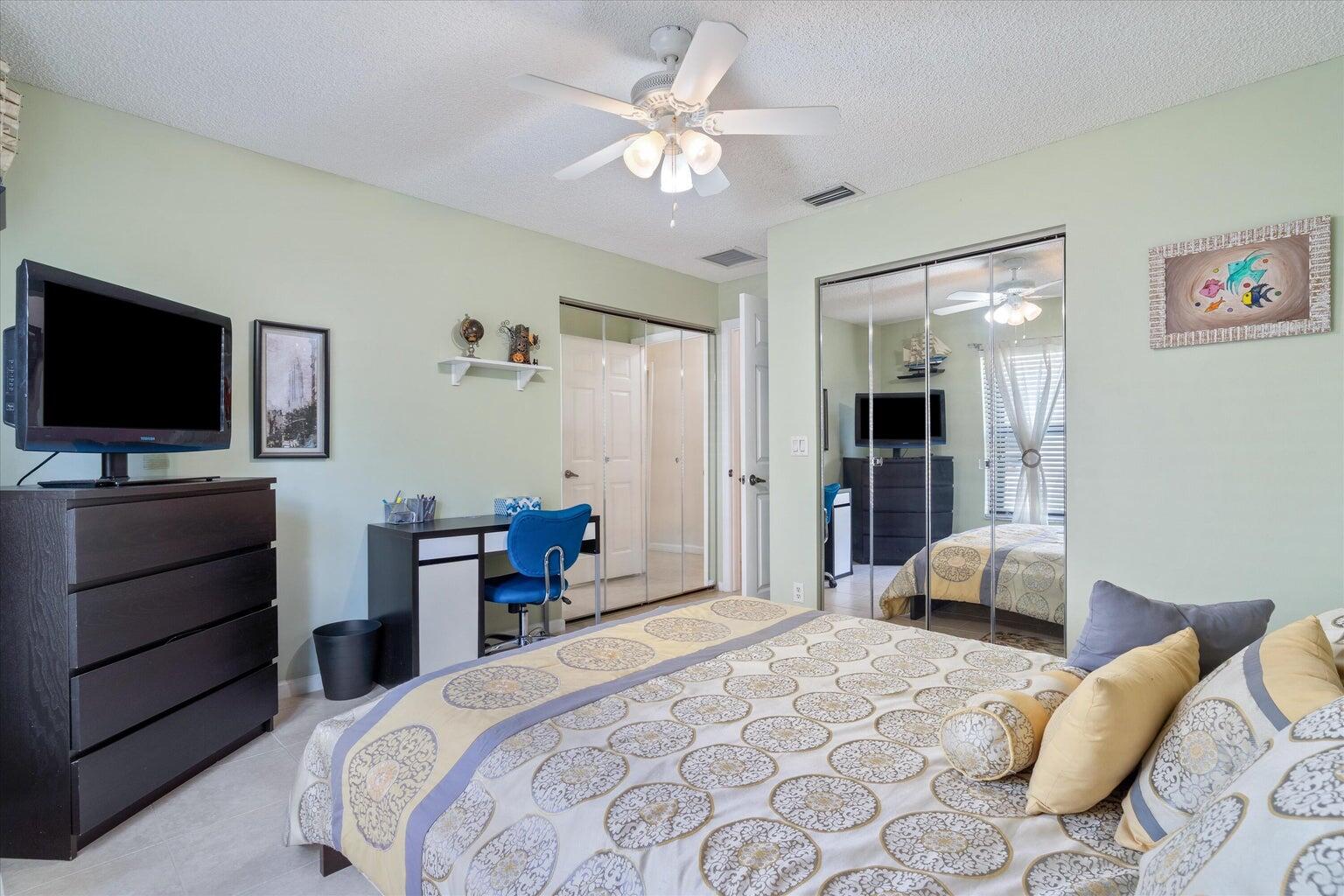 11241 Island Lakes Lane Boca Raton, FL 33498 - Photo 20 of 47 a bedroom with a bed and a flat screen tv