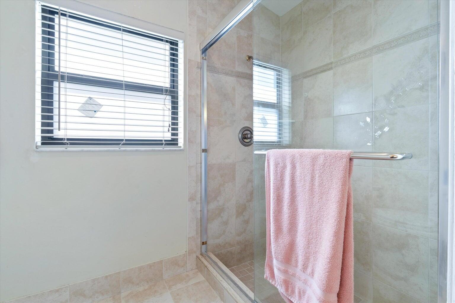 11241 Island Lakes Lane Boca Raton, FL 33498 - Photo 22 of 47 a bathroom with a window and a shower