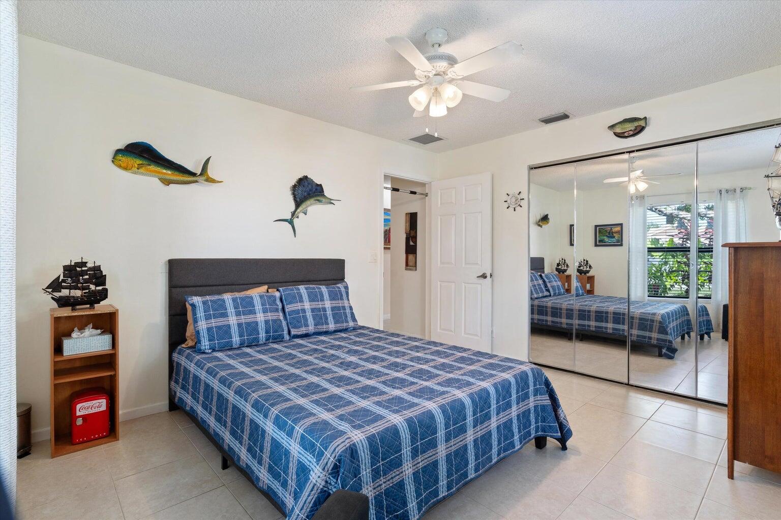 11241 Island Lakes Lane Boca Raton, FL 33498 - Photo 25 of 47 a bedroom with a large bed and a chandelier