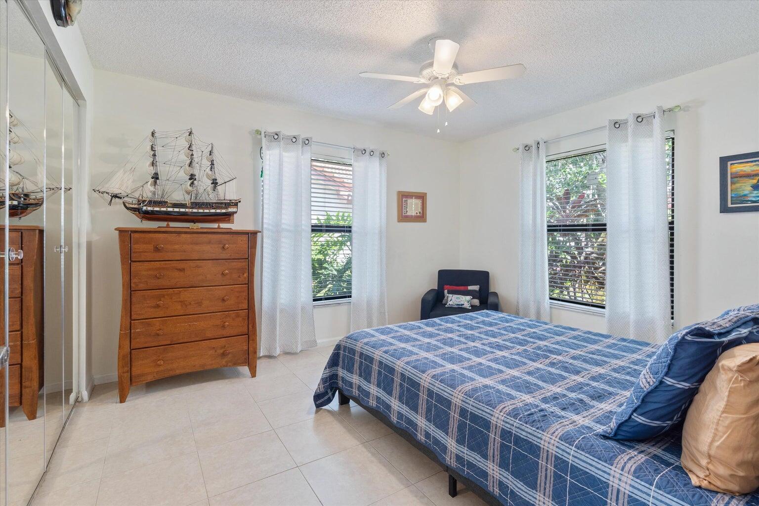 11241 Island Lakes Lane Boca Raton, FL 33498 - Photo 26 of 47 a bedroom with a bed a dresser and a window