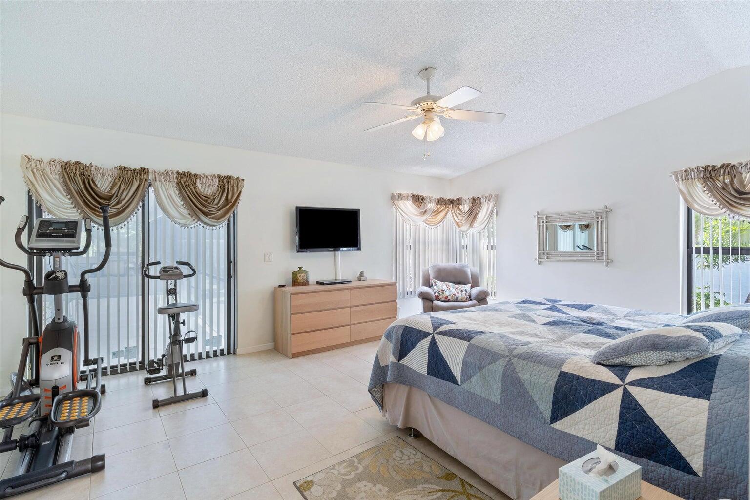 11241 Island Lakes Lane Boca Raton, FL 33498 - Photo 31 of 47 a living room with furniture and a flat screen tv