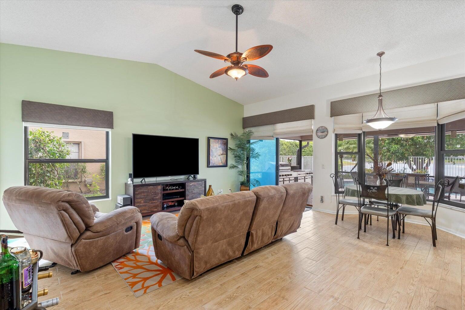 11241 Island Lakes Lane Boca Raton, FL 33498 - Photo 34 of 47 a living room with furniture and a flat screen tv