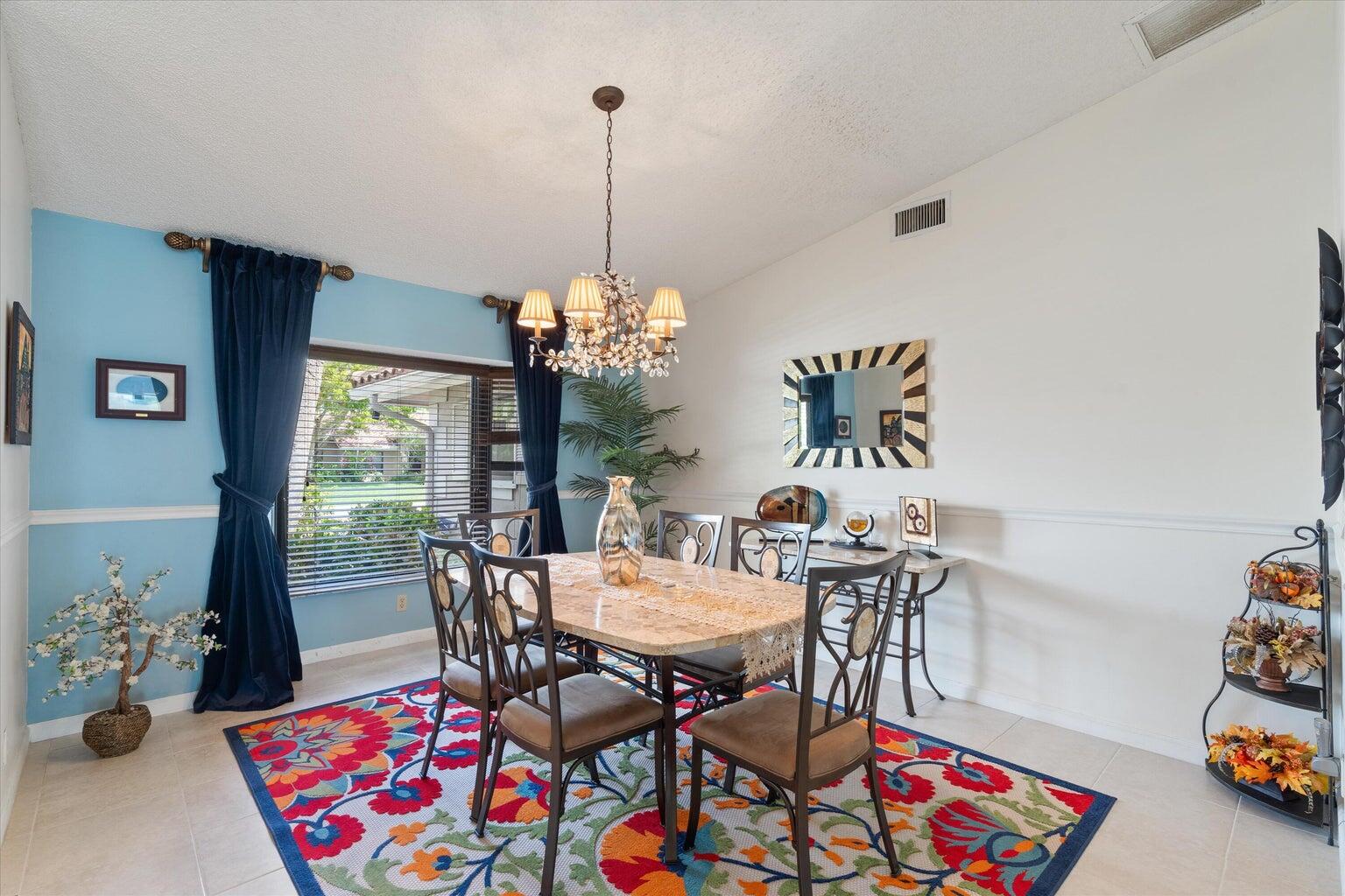 11241 Island Lakes Lane Boca Raton, FL 33498 - Photo 36 of 47 a view of a dining room with furniture and chandelier