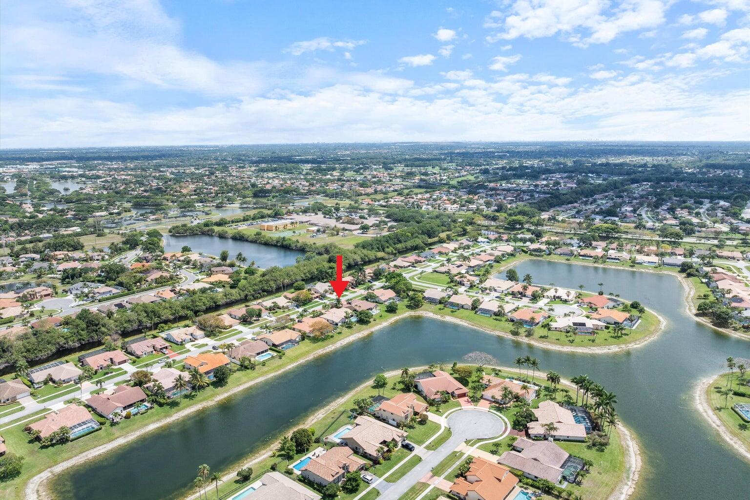 11241 Island Lakes Lane Boca Raton, FL 33498 - Photo 4 of 47 an aerial view of a city with lots of residential buildings lake and ocean view
