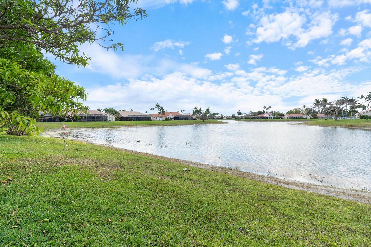 11241 Island Lakes Lane Boca Raton, FL 33498 - Photo 9 of 47 a view of a lake with houses in the back