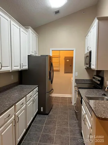a kitchen with a stove a refrigerator and a sink