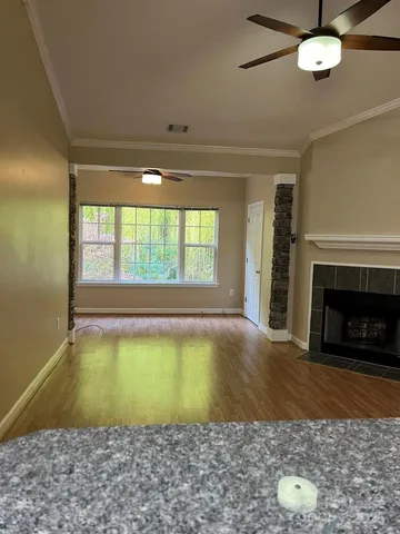 a view of an empty room with a fireplace and a window