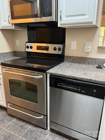 a stove top oven sitting inside of a kitchen