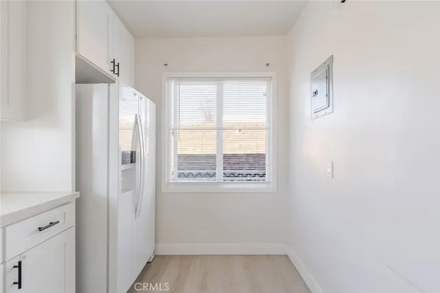 a backyard of a house with barbeque oven and plants