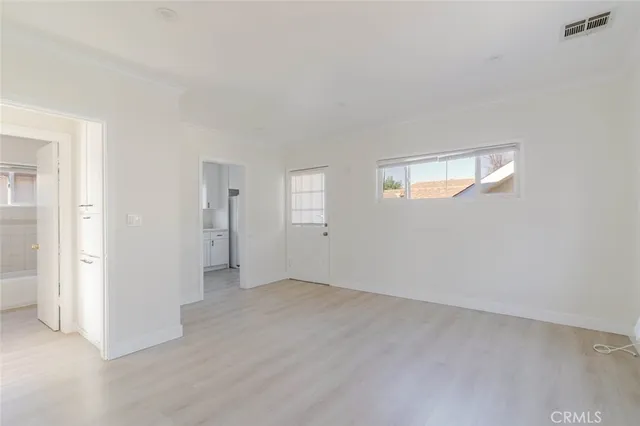 an empty room with windows and closet