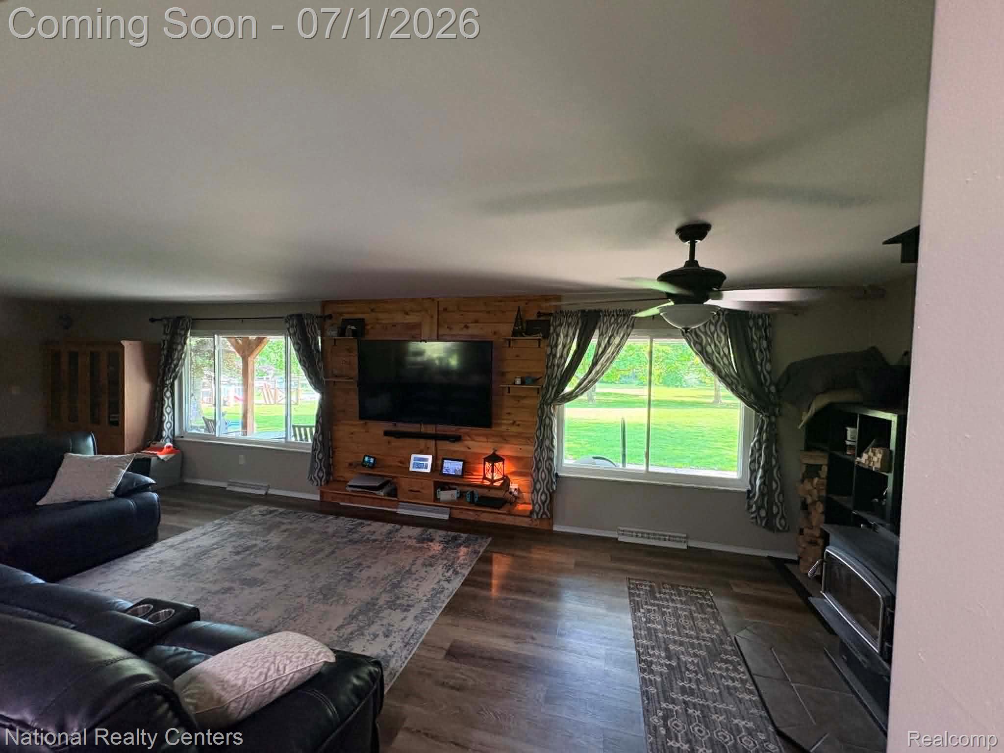 1330 Brauer Road Oxford, MI 48371 - Photo 45 of 54 Spacious living area featuring wood-finish flooring, a ceiling fan with integrated lighting, and multiple windows