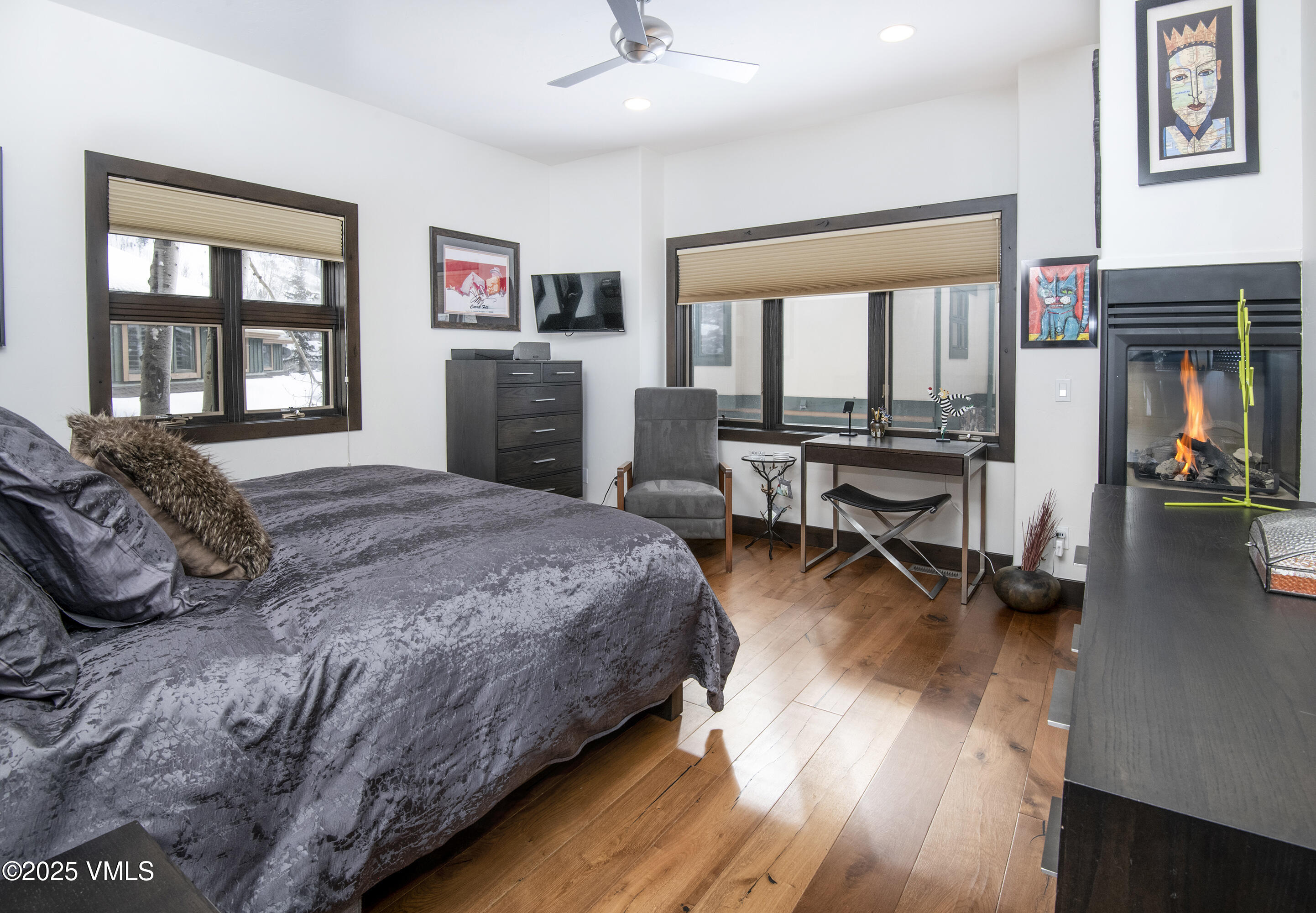 1890 Lions Ridge Loop, Unit 8 Vail, CO 81657 - Photo 13 of 39 a spacious bedroom with a bed a table and large windows
