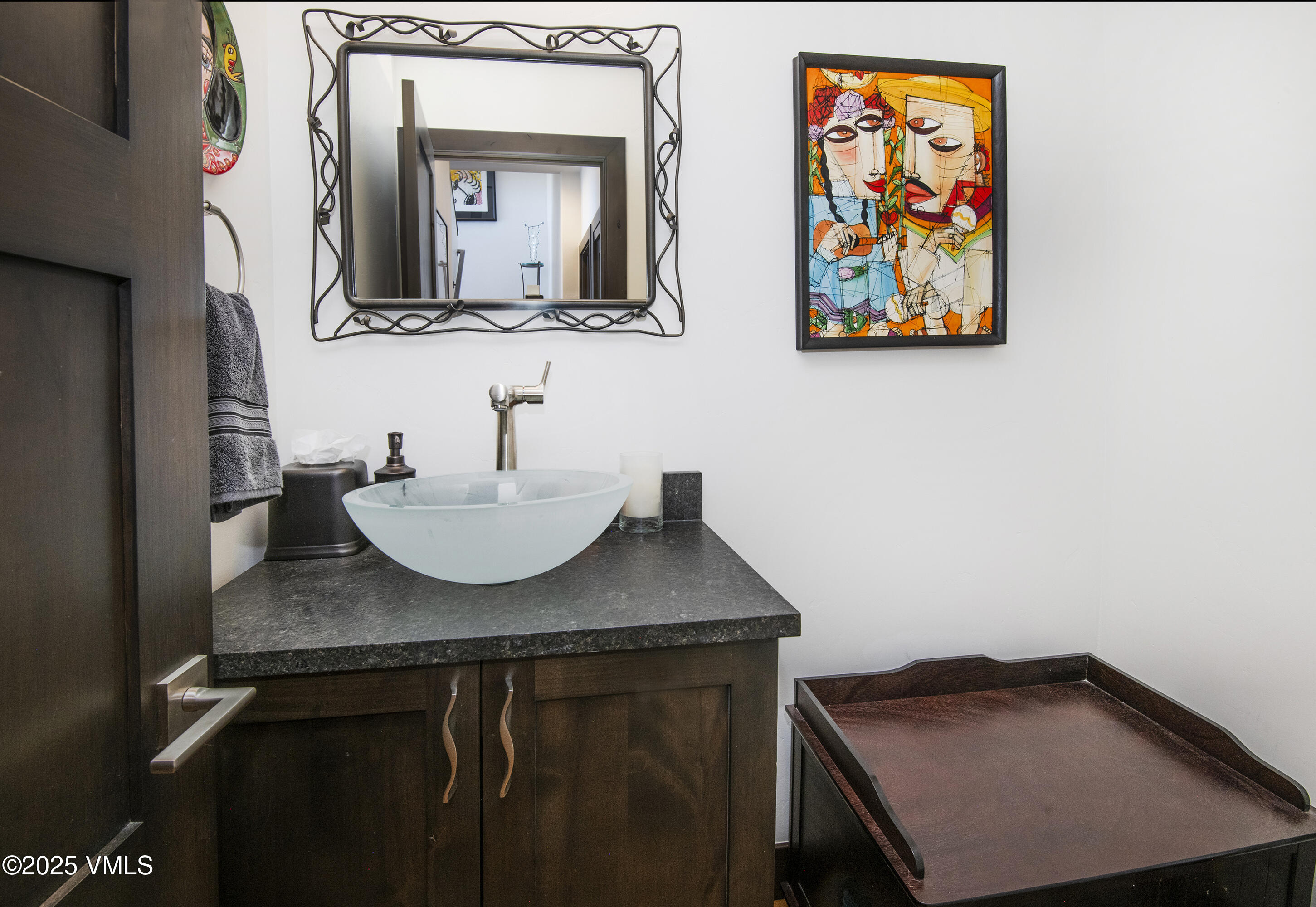1890 Lions Ridge Loop, Unit 8 Vail, CO 81657 - Photo 20 of 39 a bathroom with a sink a mirror and painting on the wall