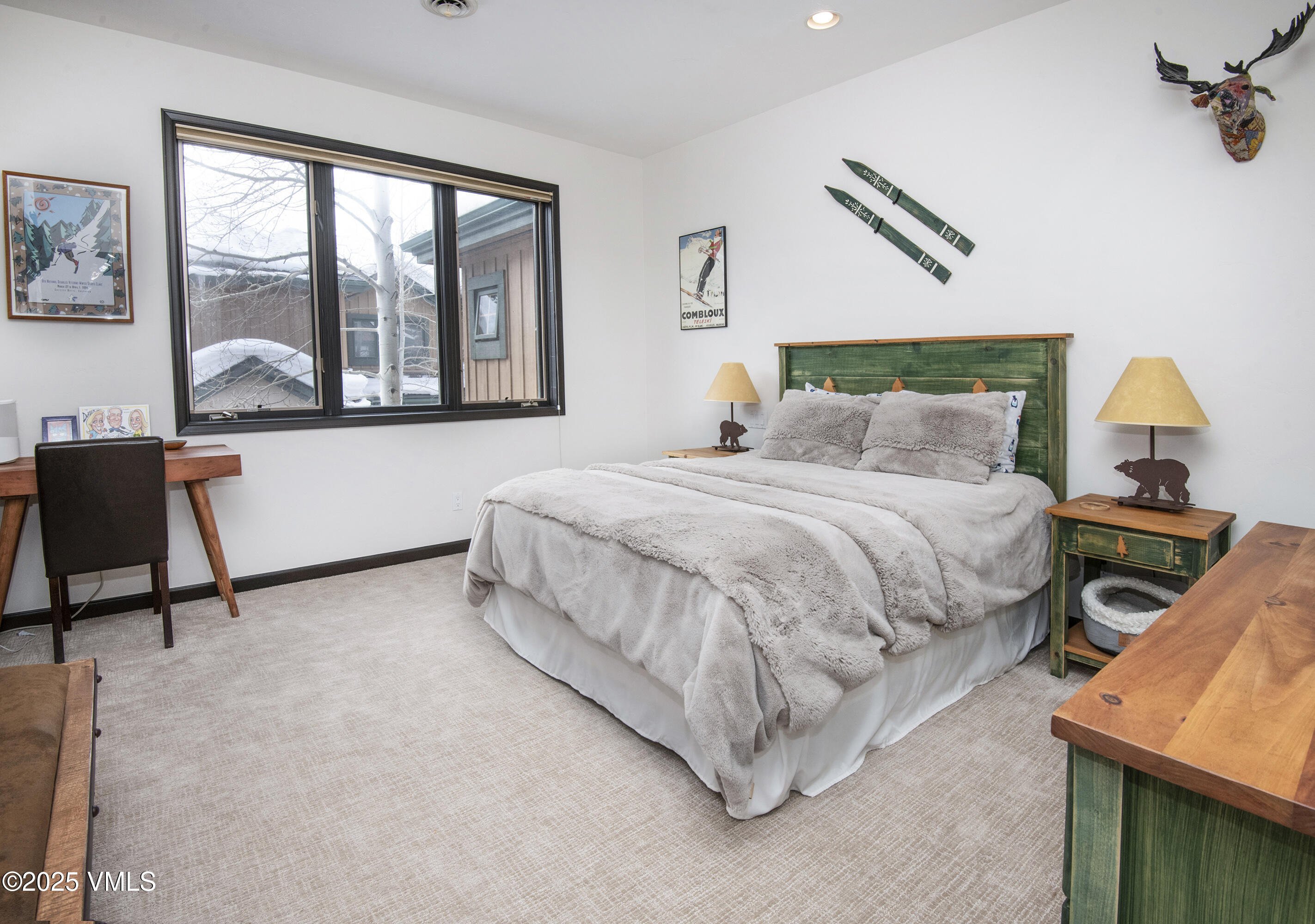1890 Lions Ridge Loop, Unit 8 Vail, CO 81657 - Photo 24 of 39 a bedroom with a bed a table and painting next to a window