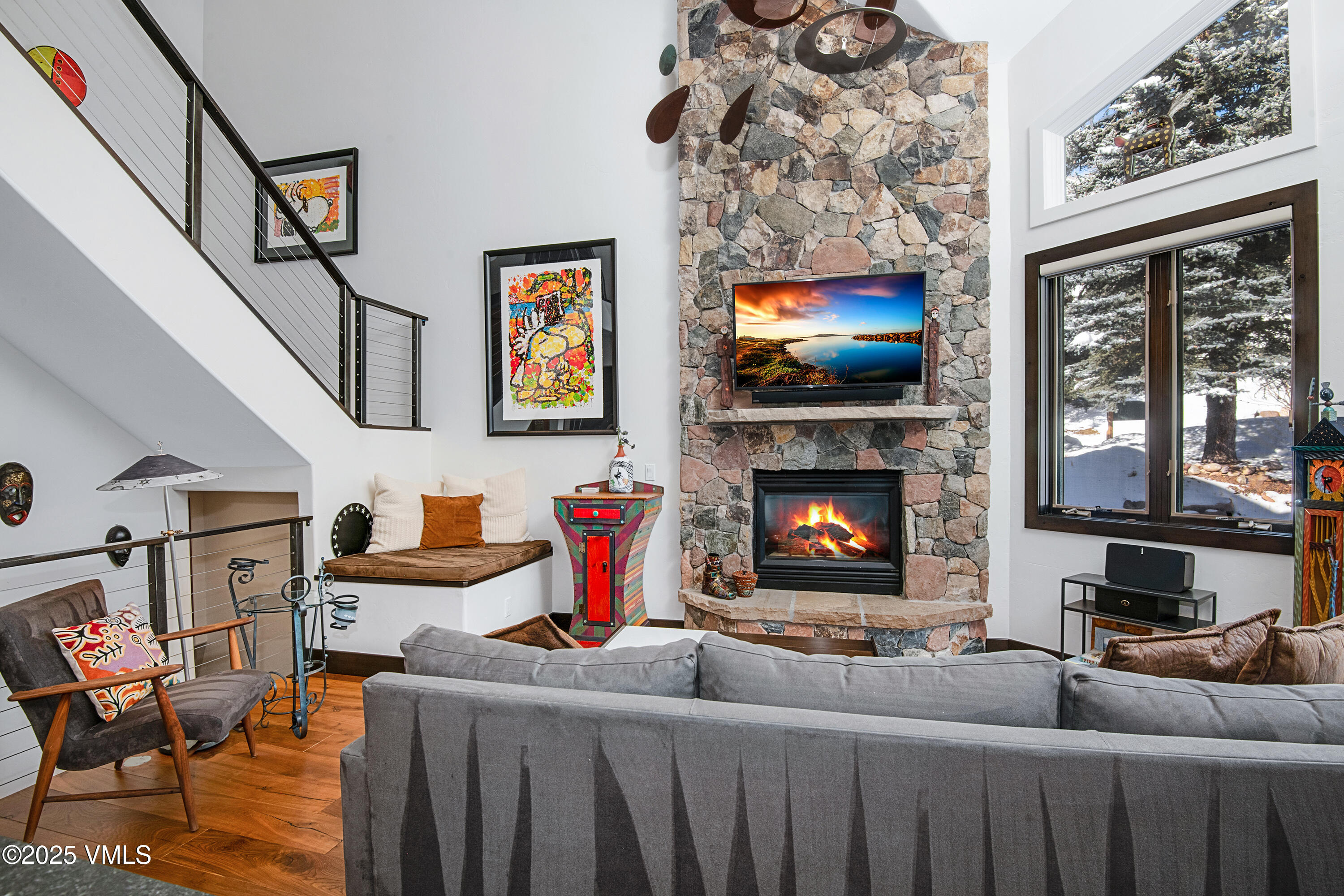 1890 Lions Ridge Loop, Unit 8 Vail, CO 81657 - Photo 3 of 39 a living room with furniture a flat screen tv and a fireplace