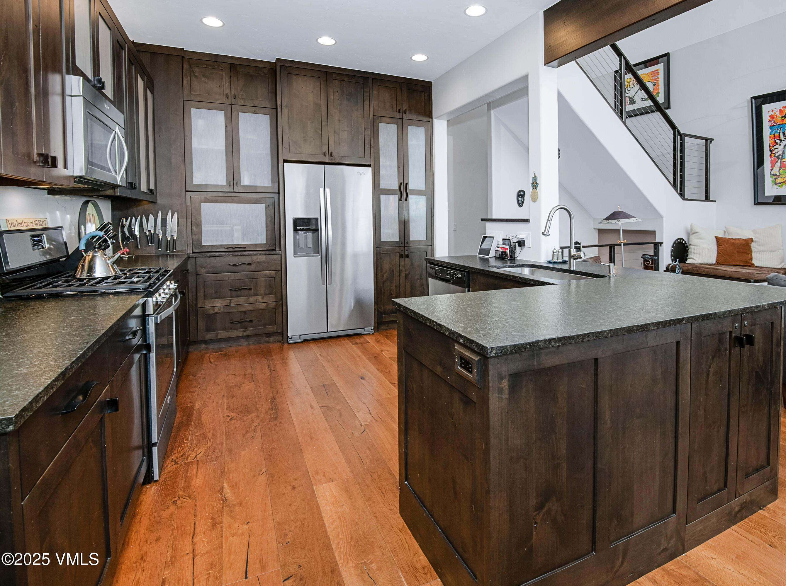 1890 Lions Ridge Loop, Unit 8 Vail, CO 81657 - Photo 6 of 39 a kitchen with kitchen island granite countertop a sink a counter top space stainless steel appliances and cabinets