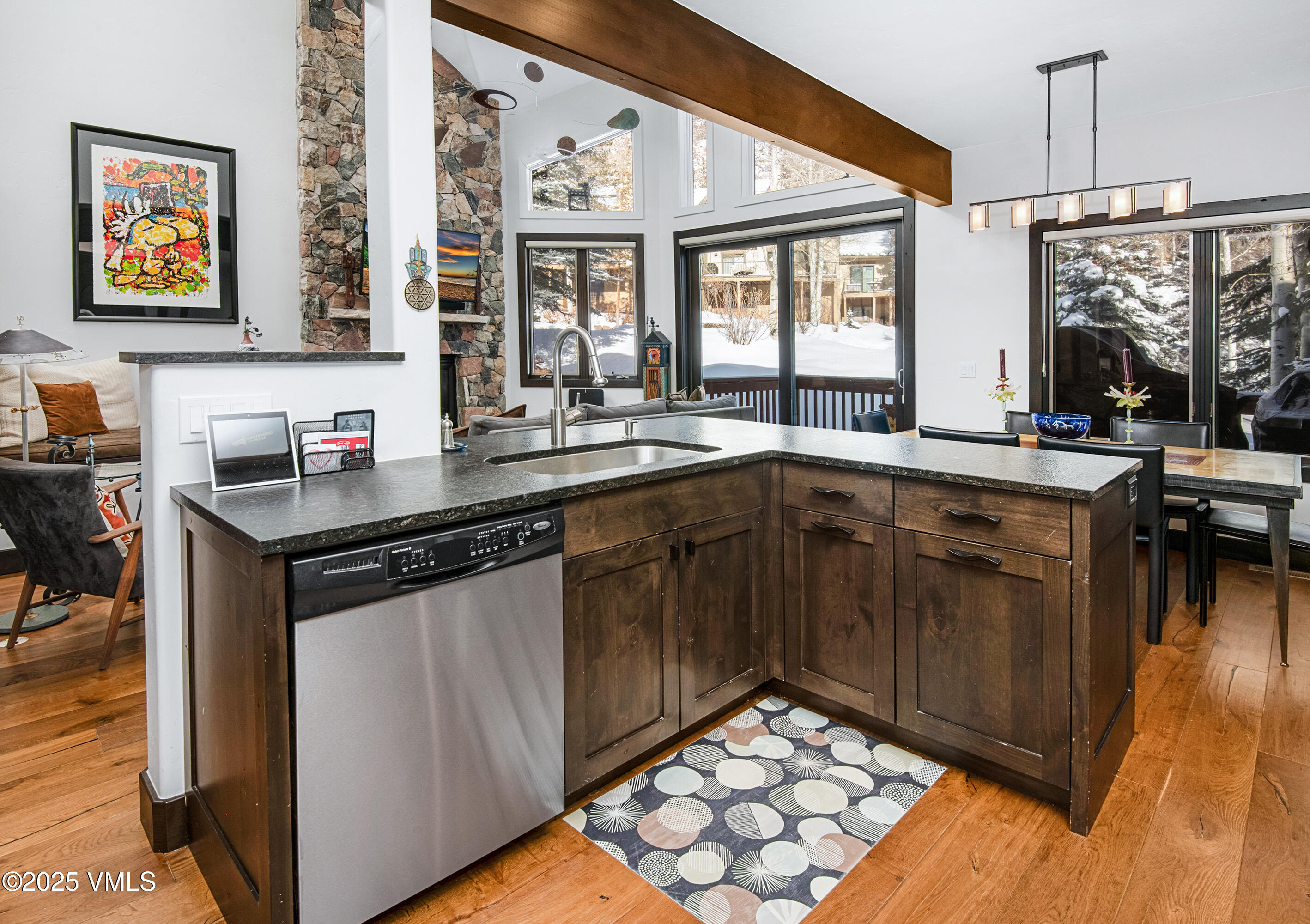 1890 Lions Ridge Loop, Unit 8 Vail, CO 81657 - Photo 7 of 39 a kitchen with stainless steel appliances granite countertop a stove a sink and a microwave