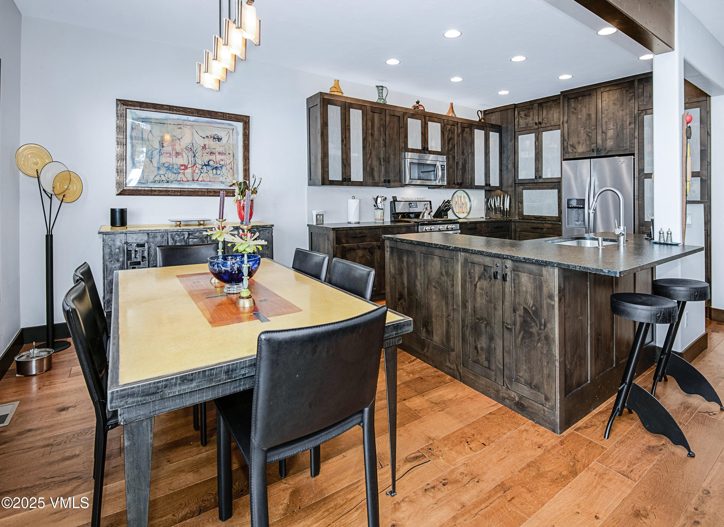 1890 Lions Ridge Loop, Unit 8 Vail, CO 81657 - Photo 9 of 39 a large kitchen with kitchen island a dining table and chairs