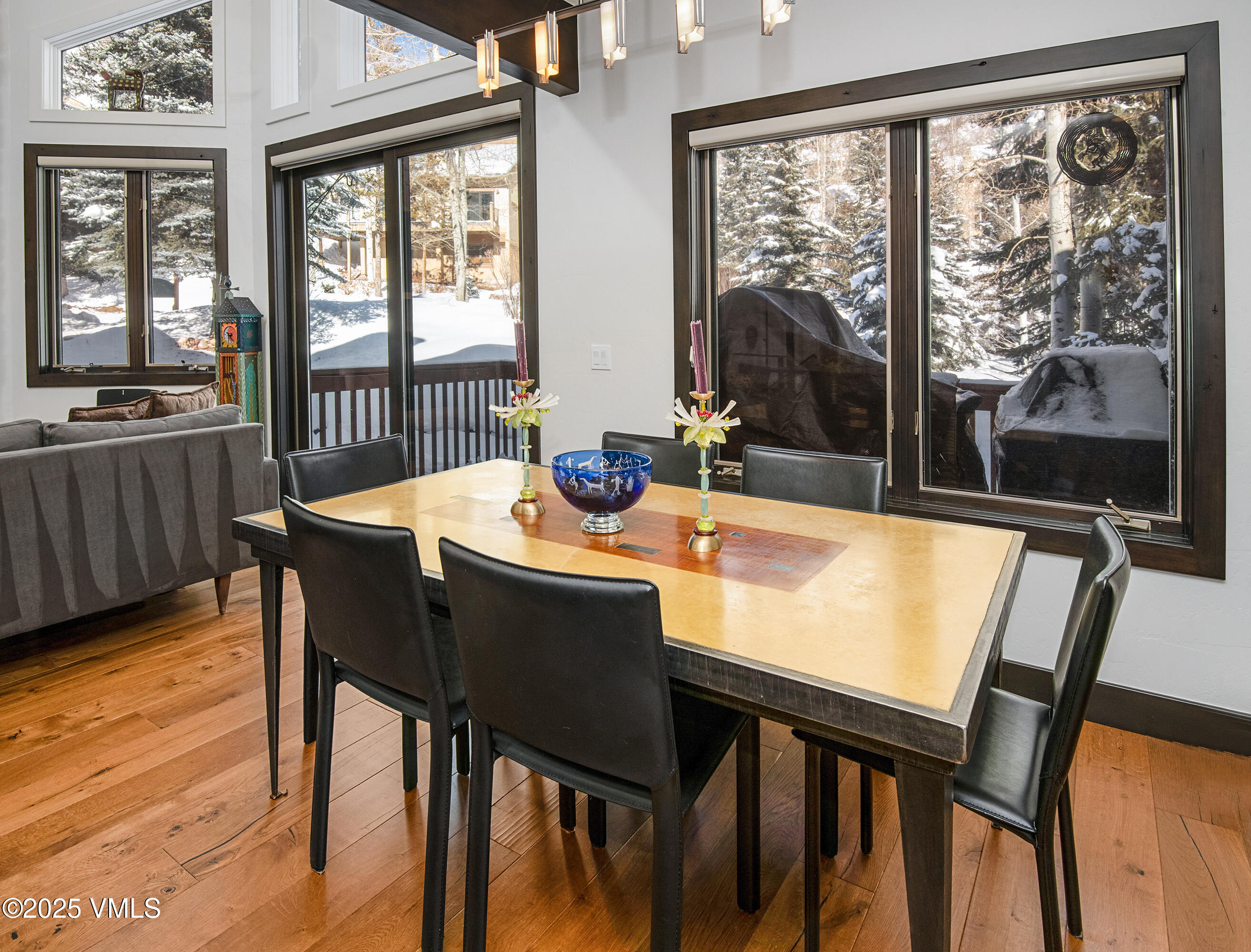 1890 Lions Ridge Loop, Unit 8 Vail, CO 81657 - Photo 10 of 39 a dining room with furniture a chandelier and wooden floor