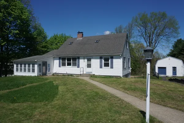 a front view of a house with a garden