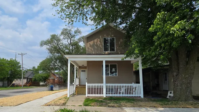 a house that has a tree in front of the house