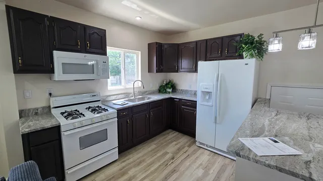 a kitchen with a refrigerator stove and microwave