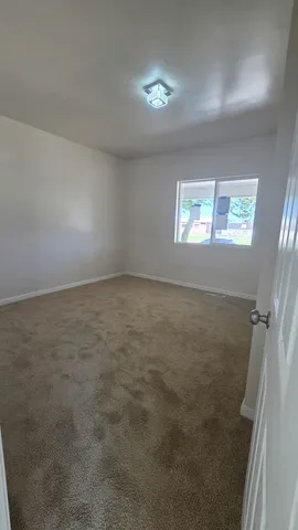 en empty room with windows and closet