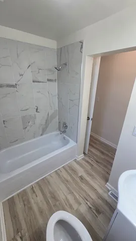 a bathroom with a shower and a toilet