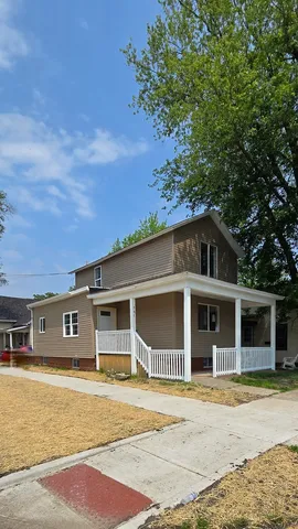 a front view of a house with a garden