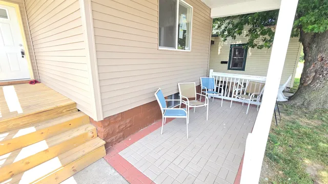 a balcony with wooden floor and furniture