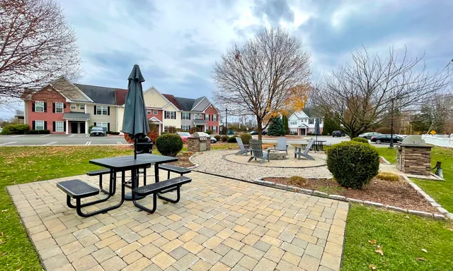 a view of a building with garden and sitting area