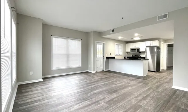a view of a kitchen with a sink and a refrigerator