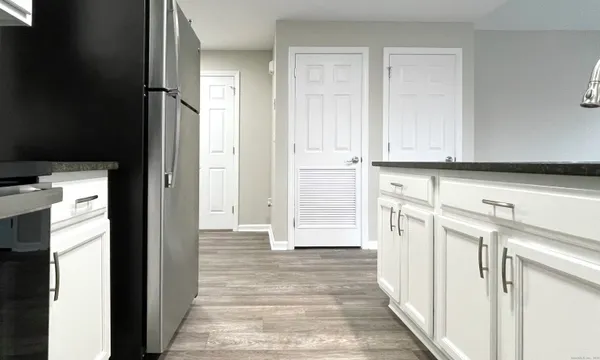 a view of a kitchen with white cabinets