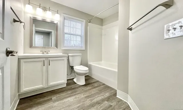 a bathroom with a sink toilet and shower