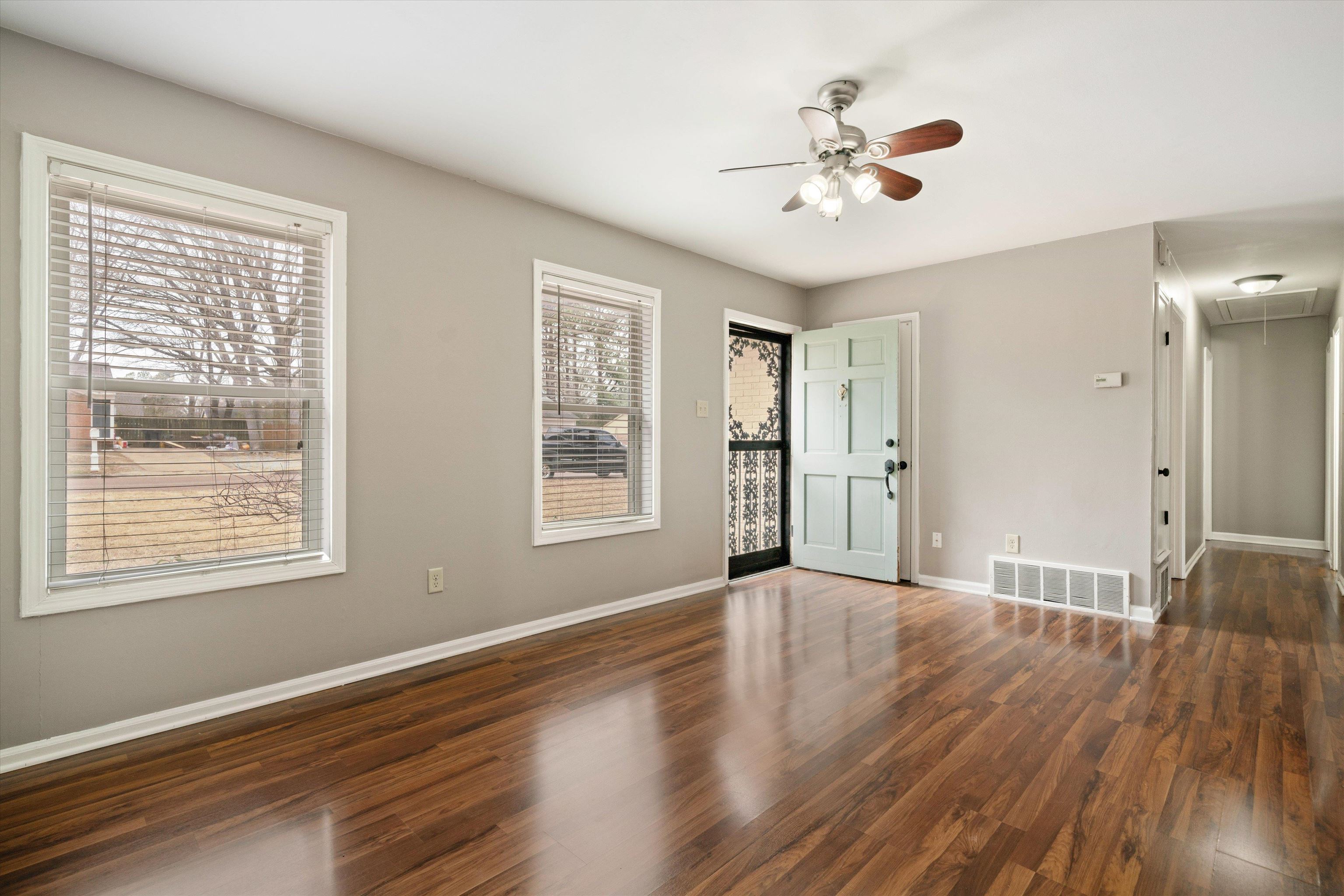 852 Greencliff Road Collierville, TN 38017 - Photo 4 of 17 a view of an empty room with a window and wooden floor