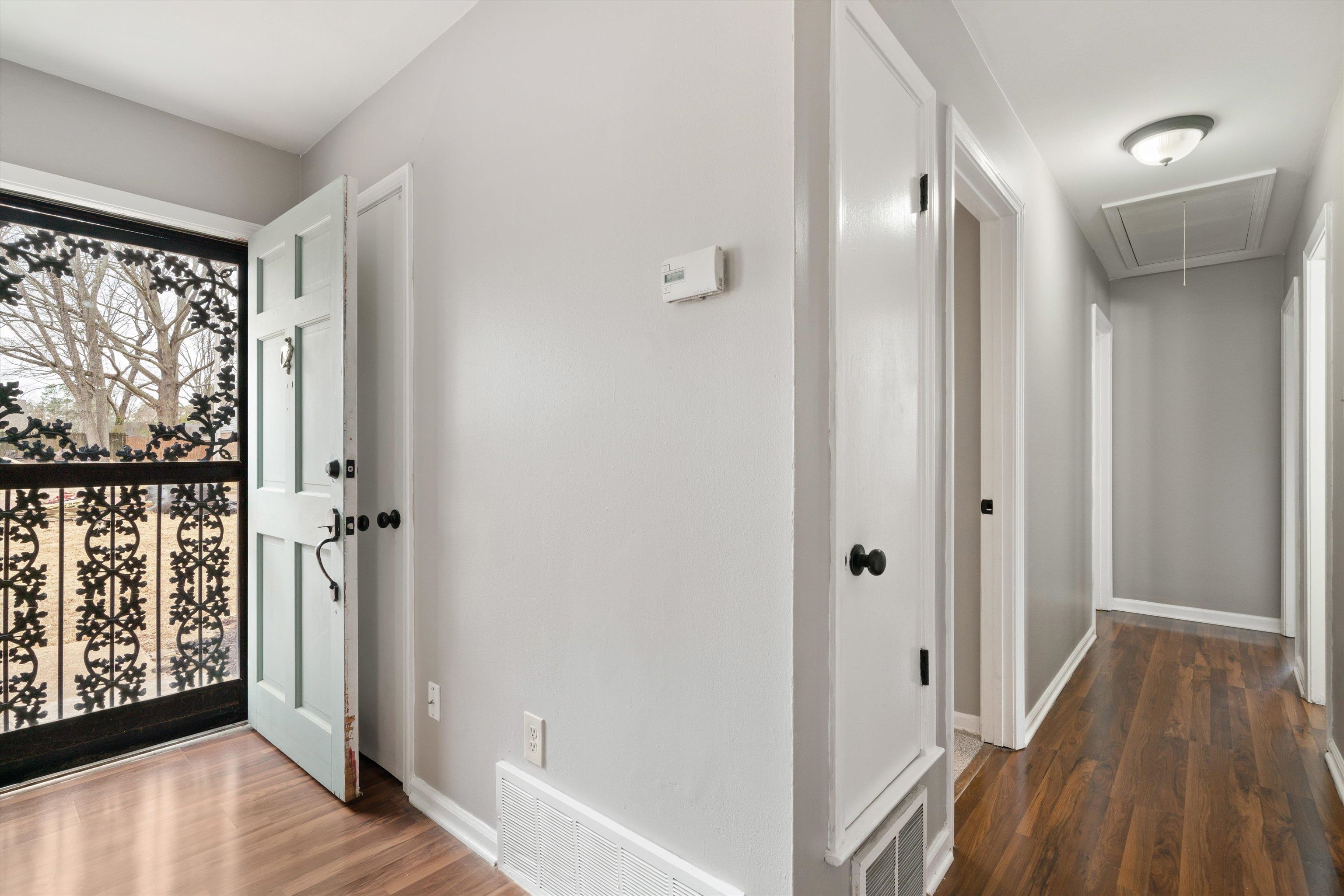 852 Greencliff Road Collierville, TN 38017 - Photo 9 of 17 a view of a hallway with wooden floor and a bathroom