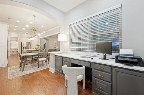 a kitchen with a sink cabinets and dining table chair