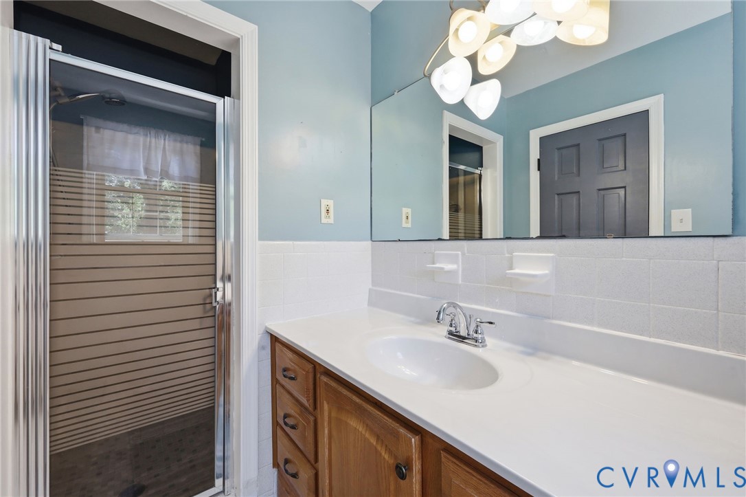 11200 Surry Road Chester, VA 23831 - Photo 26 of 48 a bathroom with a sink and a mirror