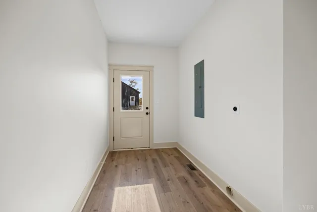 a view of a room with wooden floor