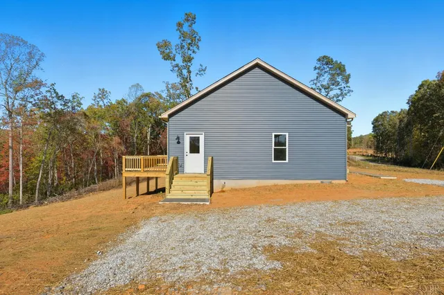a view of a house with a yard and sitting area