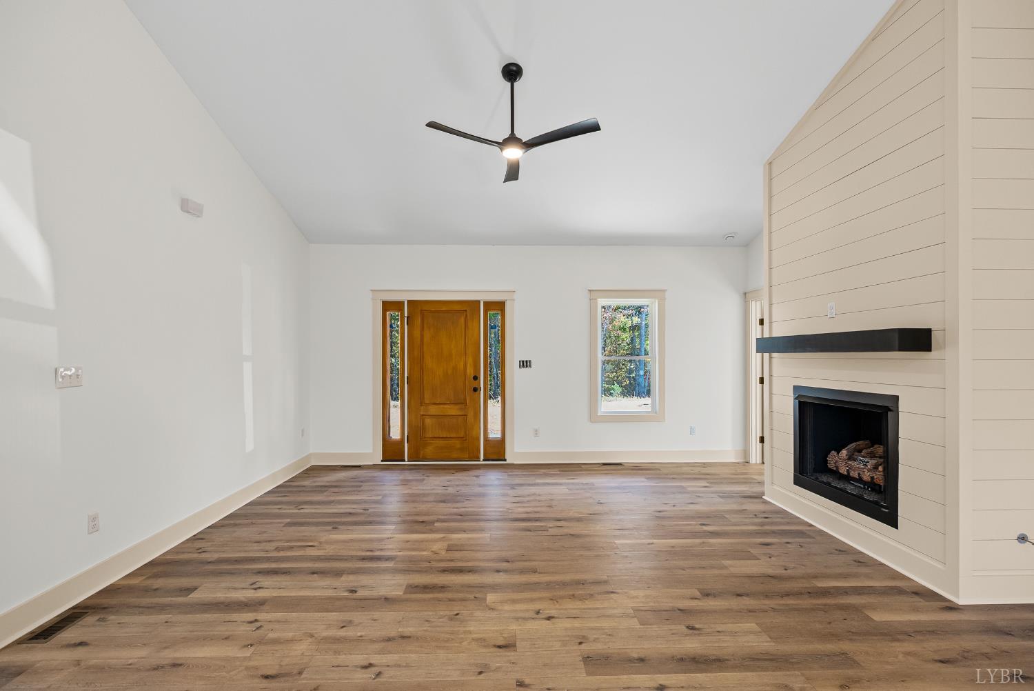 2180 Earley Farm Road Amherst, VA 24521 - Photo 3 of 35 a view of an empty room with wooden floor fireplace and a window