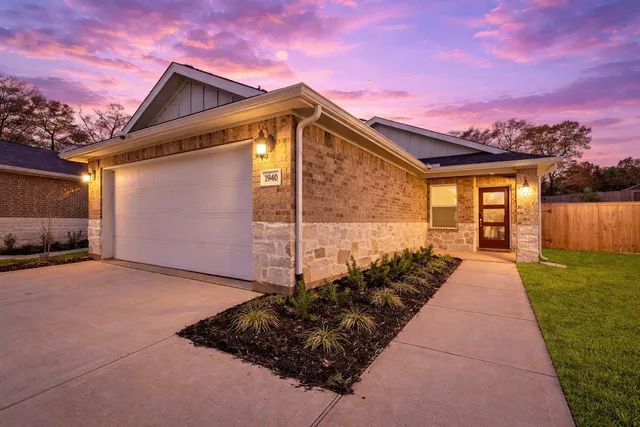 a front view of a house with a garden