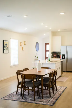 a dining room with furniture and a window